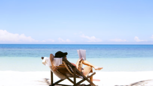 Photo of a hotel guest using a guest app on a beach.